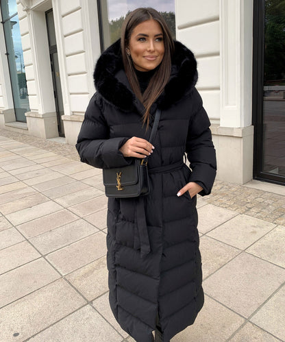 Women's long black puffer coat with a faux fur hood and quilted maxi design
