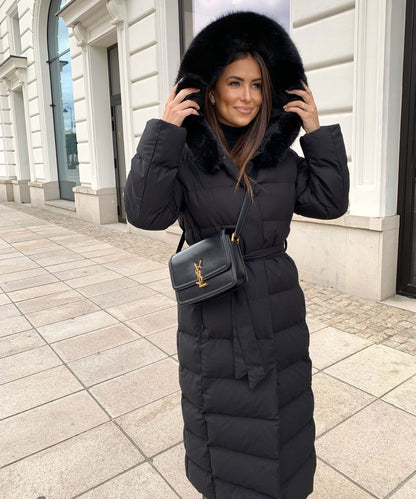 Women's long black puffer coat with a faux fur hood and quilted maxi design