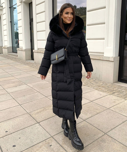 Women's long black puffer coat with a faux fur hood and quilted maxi design