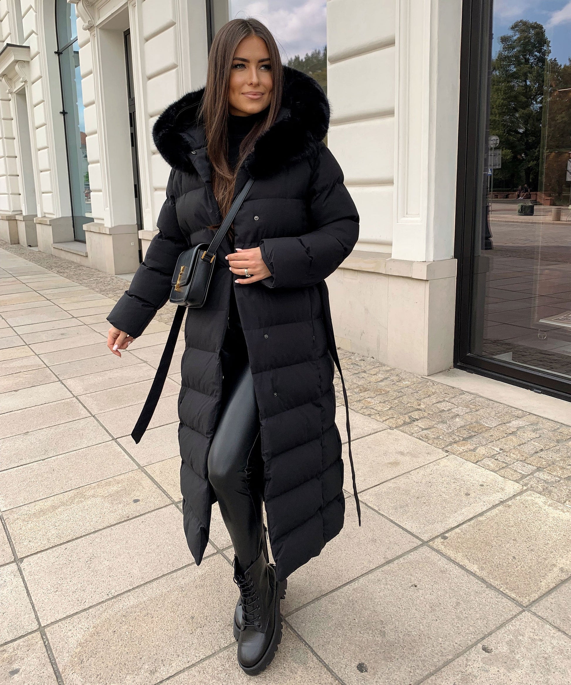 Women's long black puffer coat with a faux fur hood and quilted maxi design