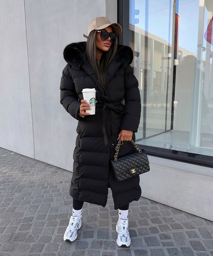 Women's long black puffer coat with a faux fur hood and quilted maxi design