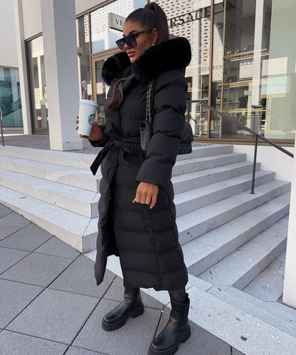 Women's long black puffer coat with a faux fur hood and quilted maxi design