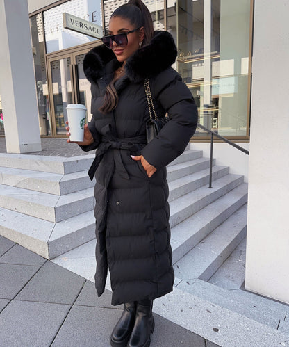Women's long black puffer coat with a faux fur hood and quilted maxi design
