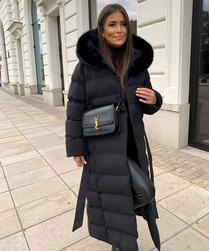 Women's long black puffer coat with a faux fur hood and quilted maxi design