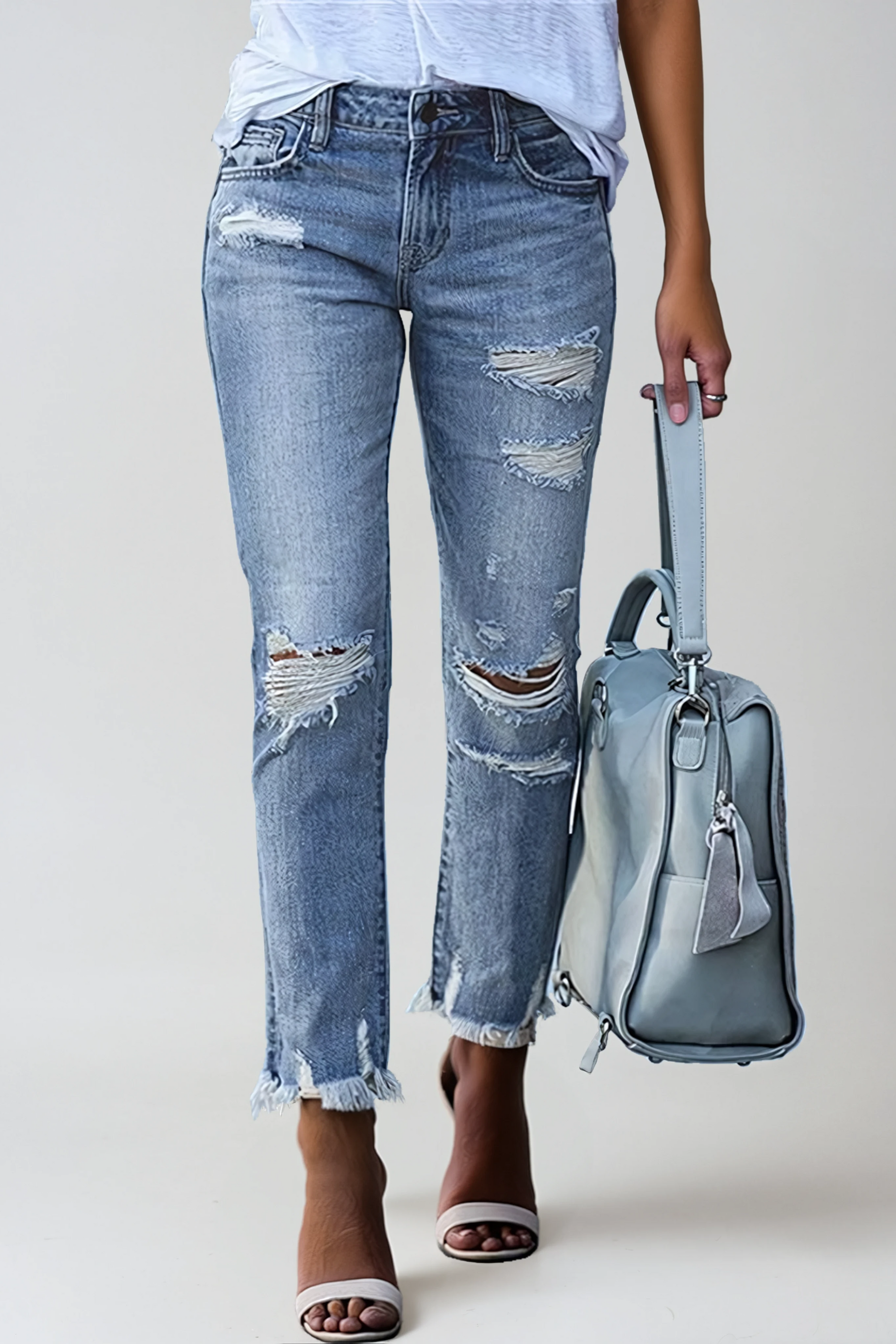 Women's distressed straight-leg jeans with a raw hem in denim