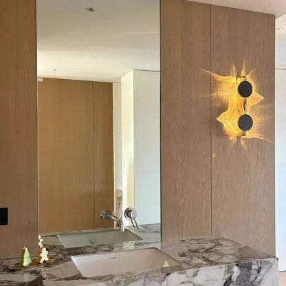Rotatable sculptural LED effect wall light