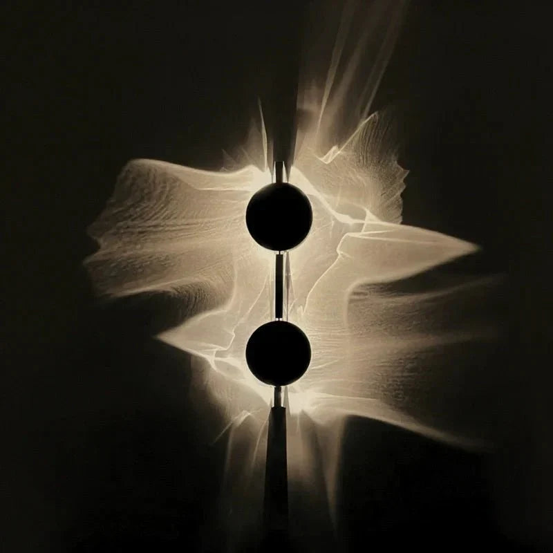 Rotatable sculptural LED effect wall light