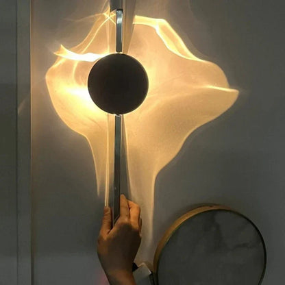 Rotatable sculptural LED effect wall light