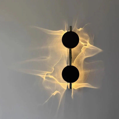 Rotatable sculptural LED effect wall light