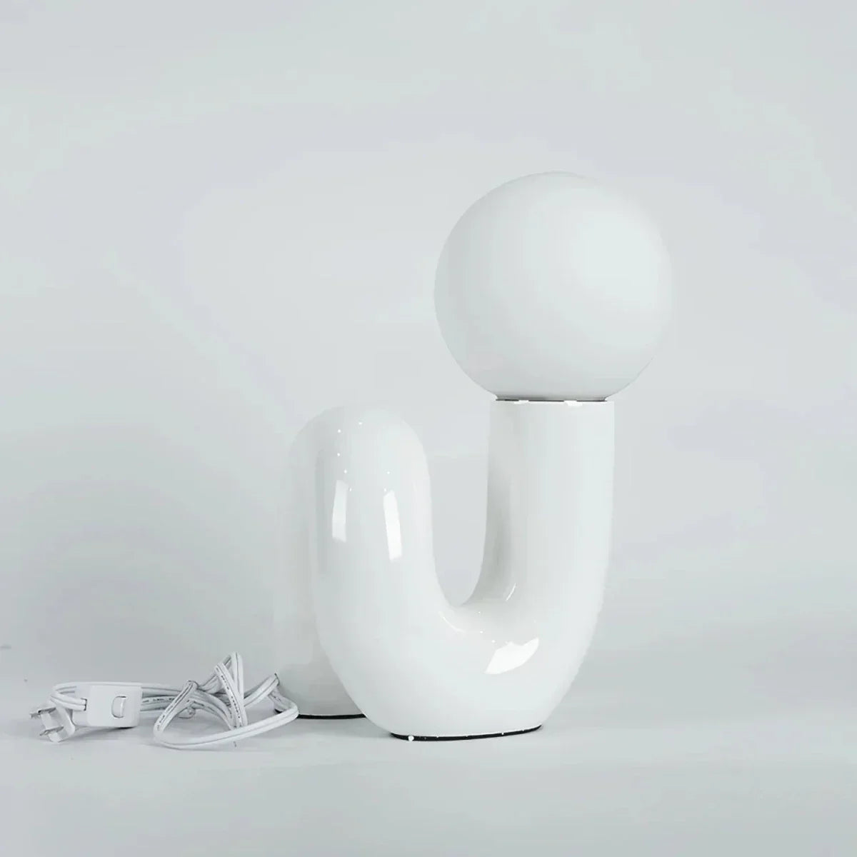 Sculptural curved glass globe table lamp
